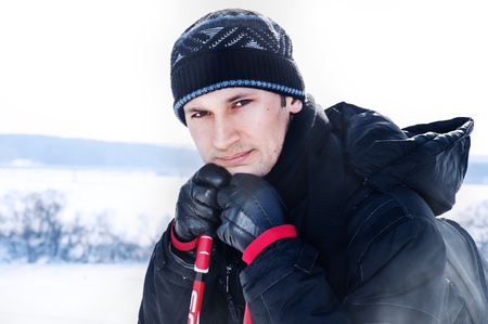 Portrait of young man skier in a winter forestの写真素材
