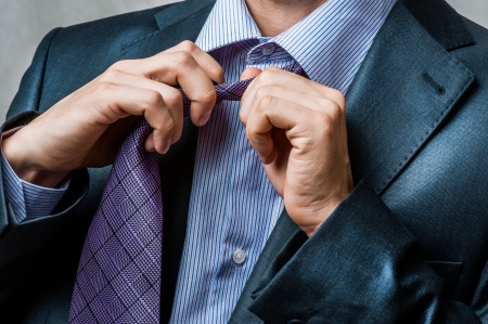  business man in suit untying his neck tie の写真素材