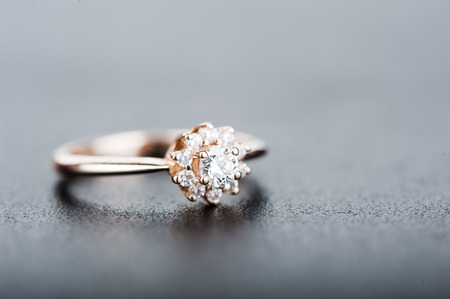 Defocus view. Beautiful ring with diamonds on gray background. Macro viewの写真素材