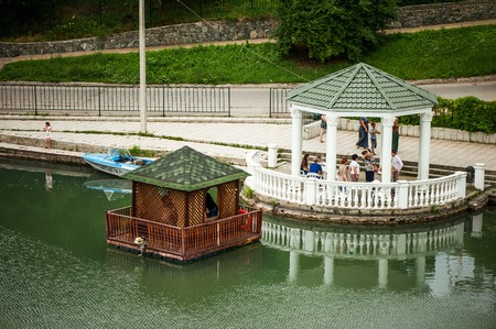 NALCHIK, RUSSIA - July 03: Tourists and citizens on embankment and arbor on water of lake in garden Atazhukinsky in July 03, 2015 in Nalchik.のeditorial素材