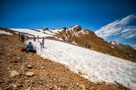 CHEGET, RUSSIA - July 05: People - tourists and climbers on Mount Cheget - 3050 m sitting and taking pictures in July 05, 2015 in Cheget, Elbrus region, Russiaのeditorial素材