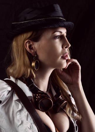 Sexy girl wearing steampunk costume on black backgroundの写真素材