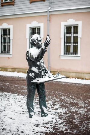 Statue of a street pharmacist selling medicine from a tray next to the museum of an old pharmacyの写真素材