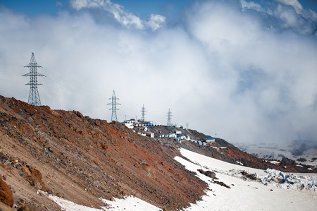 Clubs of fog and clouds move along the slope of Mount Elbrusの写真素材