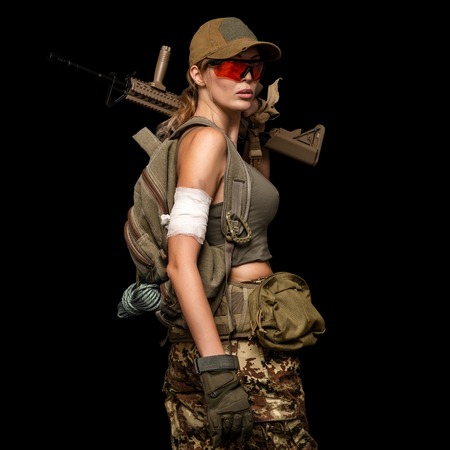 Dangerous military girl holding automatic rifle. Dooms day or war on black