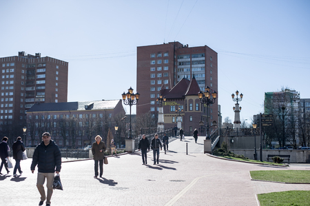 KALININGRAD, RUSSIA - APRIL 06, 2017: people walk along the embankment and across the bridge of the Pregolya River in the tourist center of Kaliningrad Fish Villageのeditorial素材
