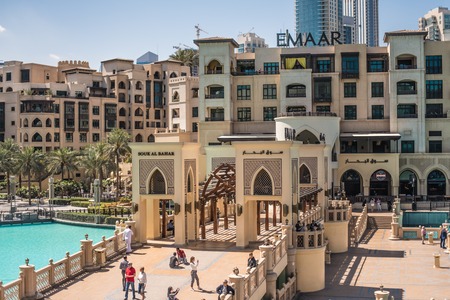 DUBAI, UNITED ARAB EMIRATES - MARCH 12, 2019: The Dubai fountain lake in the day. Tourists walking on bridge to souk al baharのeditorial素材