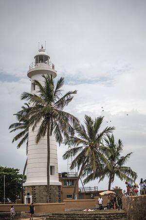 GALLE, SRI LANKA - MARCH 16, 2019: Lighthouse at Galle Fortress in Sri Lanka for palm trees by the seaのeditorial素材
