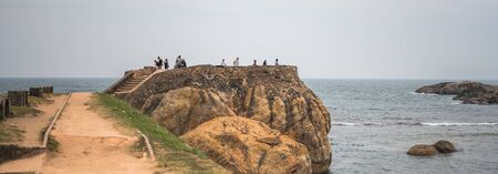 GALLE, SRI LANKA - MARCH 16, 2019: Rocks or large stones in the Indian Ocean near Galle Fort in Sri Lankaのeditorial素材