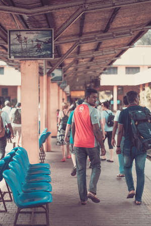 GALLE, SRI LANKA - MARCH 16, 2019: Train on station and People locals and tourists go on 1 track of the railway station platform in Galle, Sri Lankaのeditorial素材