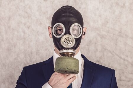 Close up portrait of handsome man in a protective gas mask, virus protection conceptの写真素材