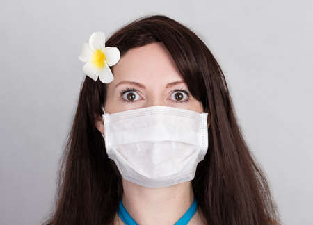Frightened tourist woman in a medical mask eyes wide open in fear, the border is closed