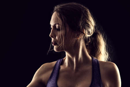 Slim beauty athletic woman on black backgroundの写真素材