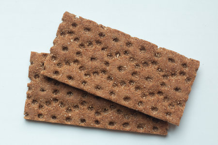 Two dietary rye healthy breads lie on a white background