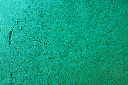 Concrete vintage wall background, old grunge wall painted with green dye. Cement wall texture.