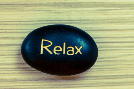 black lava stones with word of relaxationの写真素材