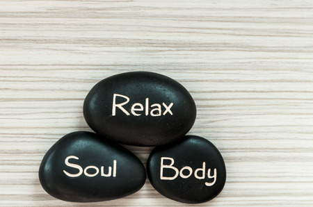 black lava stones with word of relaxationの写真素材