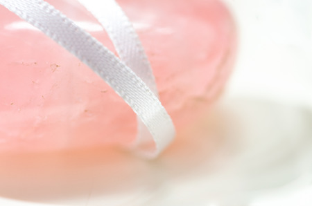 pink gemstones on white background unit with white lace