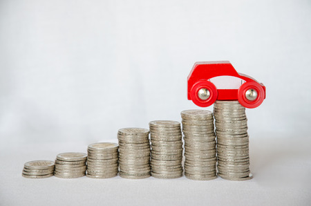 detail of coins and car on white backgroundの写真素材