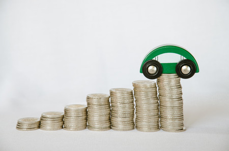 detail of coins and car on white backgroundの写真素材