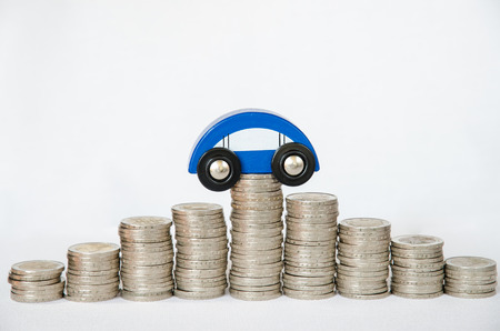 detail of coins and car on white backgroundの写真素材
