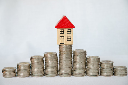 detail of coins and house on white backgroundの写真素材