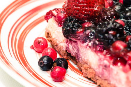 colorful fruity cake with fruits on a plateの写真素材