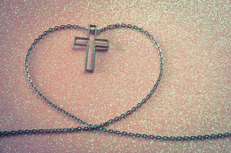 silver cross symbol in love shape imageの写真素材