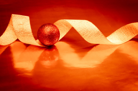 red ball and ribbon over shining backgroundの写真素材