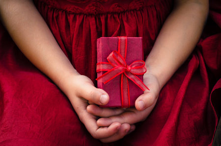 red gift box in children handsの写真素材