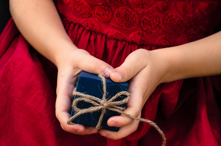blue gift box in children handsの写真素材