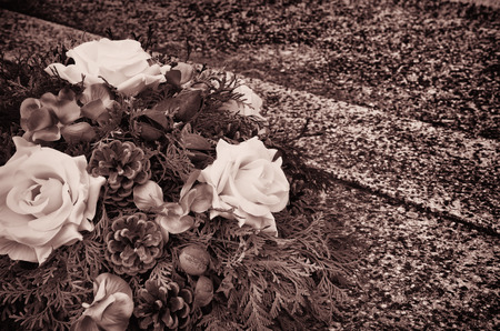 floral wreath decoration lying on the graveの写真素材