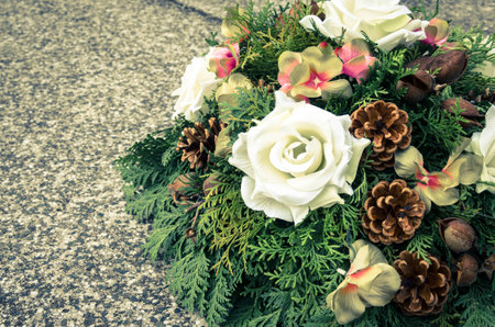 floral wreath decoration lying on the graveの写真素材