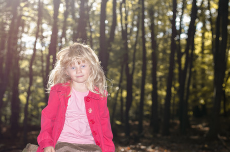 beautiful blond girl in autumn forrestの写真素材