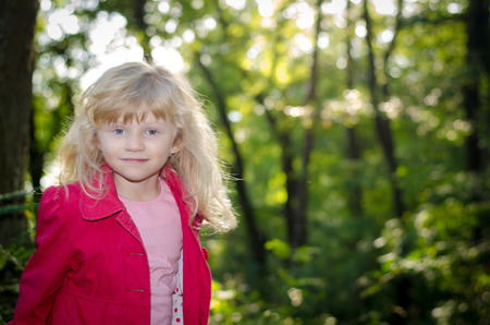 beautiful blond girl in autumn forrestの写真素材