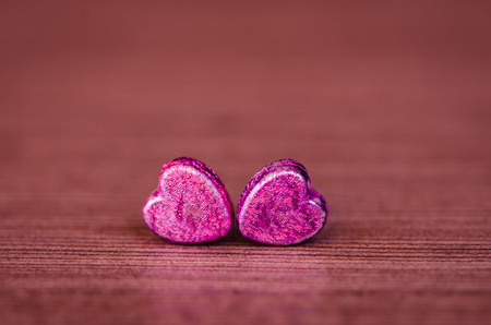 two pink hearts on violet backgroundの写真素材