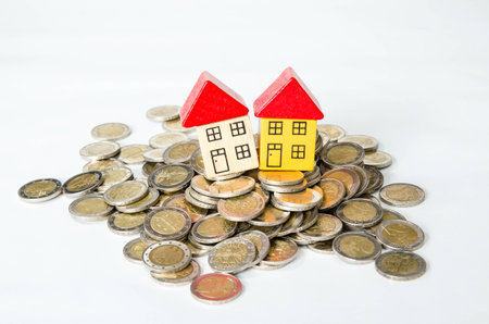 coins in pile and house isolated imageの写真素材