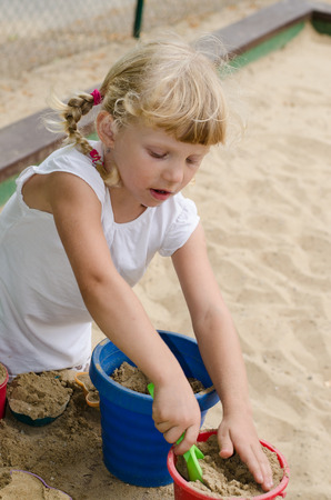 beautiful blond girl playing on playgroundの写真素材