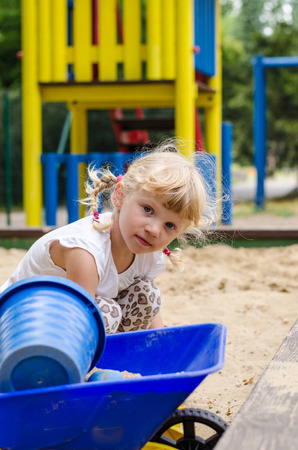 beautiful blond girl playing on playgroundの写真素材