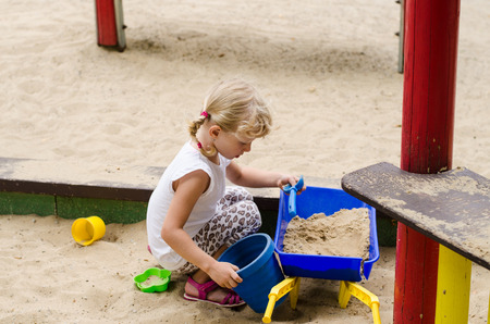beautiful blond girl playing on playgroundの写真素材