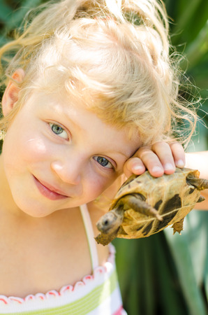 beautiful blond girl with turtle imageの写真素材