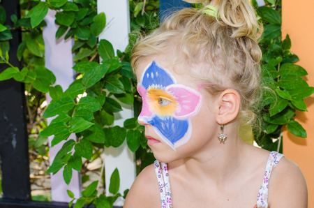beautiful blond girl with flower face painting