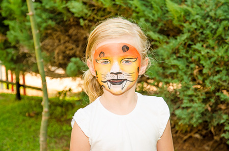 beautiful blond girl with tiger face painting