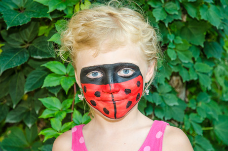 beautiful blond girls with adybug face painting