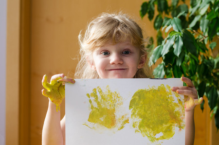 blond girl with painted image in handの写真素材