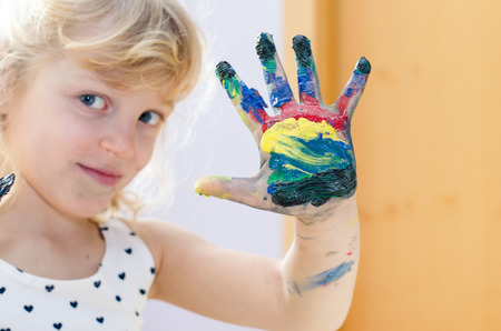 blond girl with colorful painted handhの写真素材