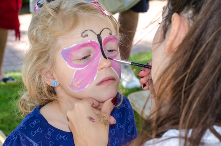 blond girl with face painting