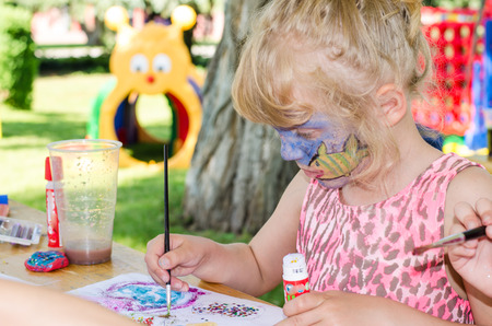 blond girl with face painting