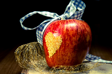 red apple with yellow heart on itの写真素材