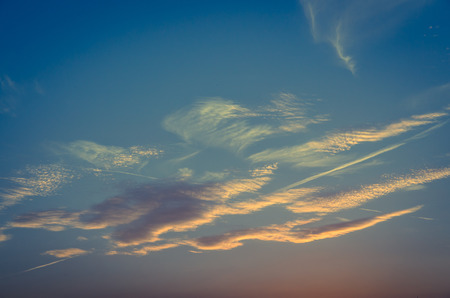 illuminated clouds on the blue sky